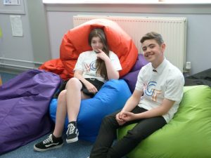 Two young people sitting on bean bags