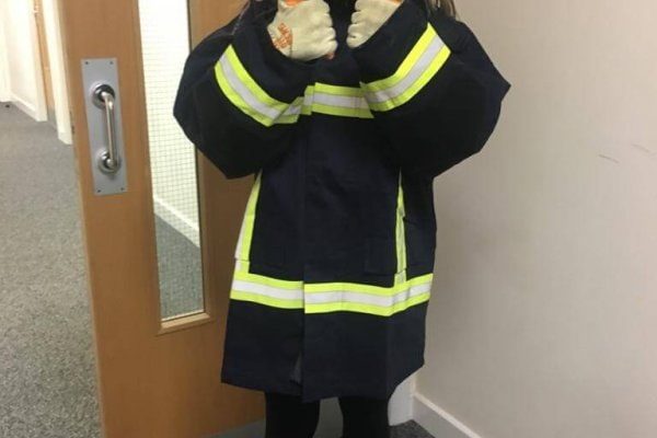 Female young Person wearing firemans outfit